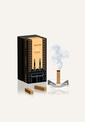 Amaani Oud Makkah bakhoor bricks with incense burner releasing smoke, luxury oud fragrance refill