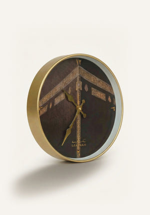 Close-up of Makkah Islamic wall clock showing Arabic numerals and gold detailing